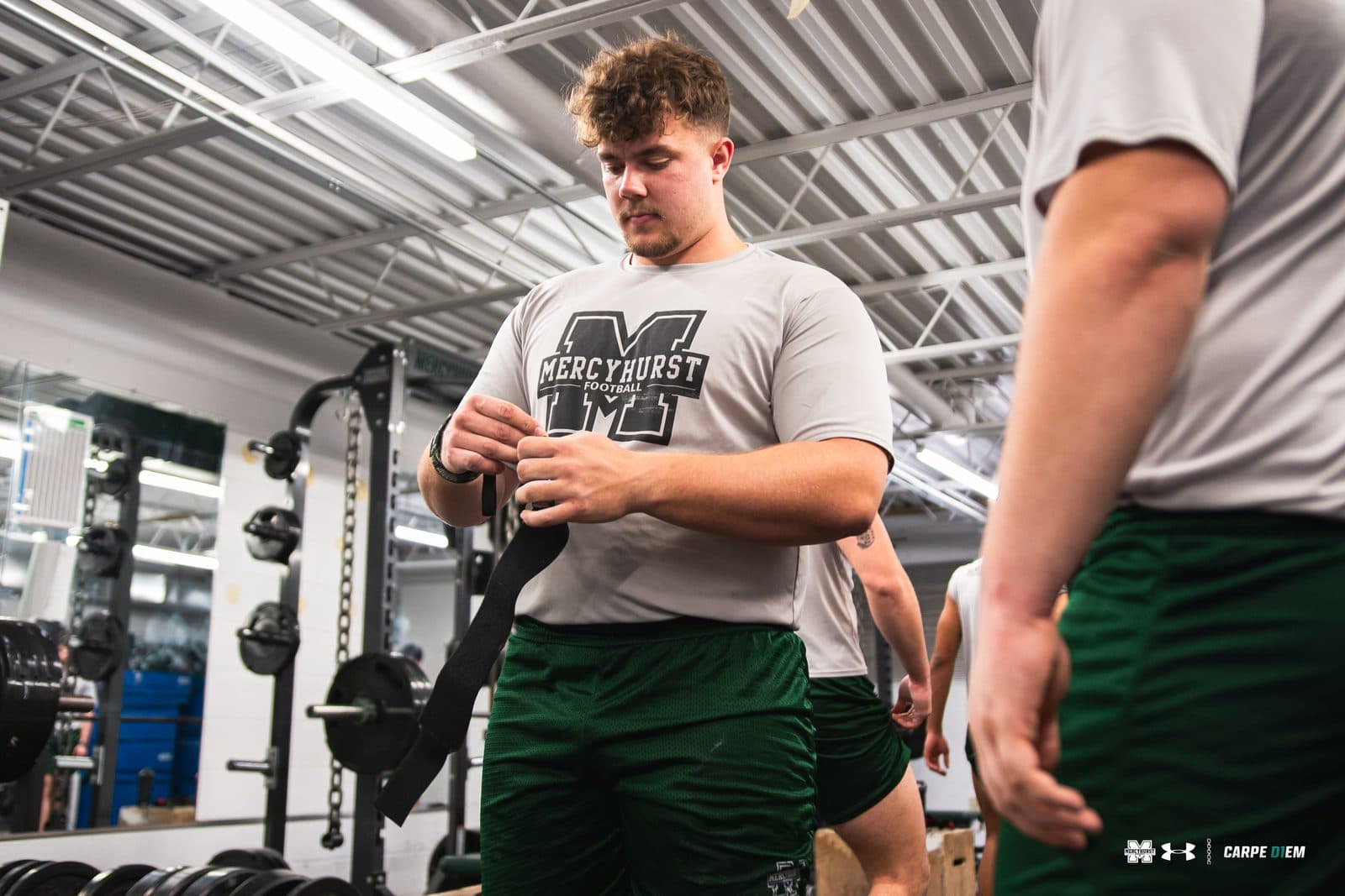Athlete strapping in at the rack before a lift